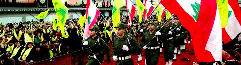 Members of militant Shiite Muslim group Hezbollah ceremony wave the Lebanese flag as well as the Hezbollah flag during a rally organised by Hezbollah marking the party's Martyrs' Day in southern Beirut, on November 12, 2012. AFP PHOTO / ANWAR AMRO (Photo credit should read ANWAR AMRO/AFP/Getty Images)